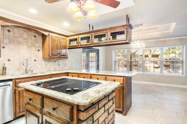 kitchen featuring a kitchen island, stainless steel dishwasher, and a healthy amount of sunlight