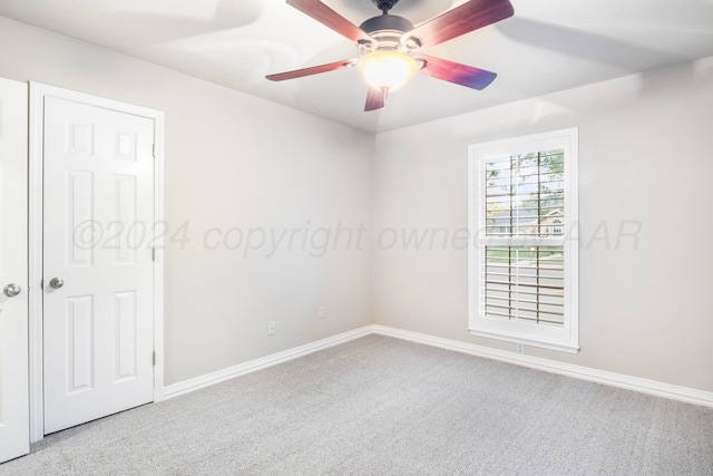 spare room with light colored carpet and ceiling fan