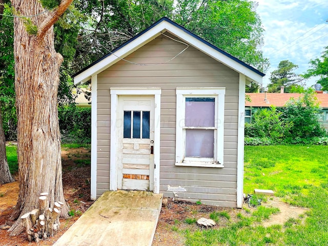 view of outbuilding featuring a lawn