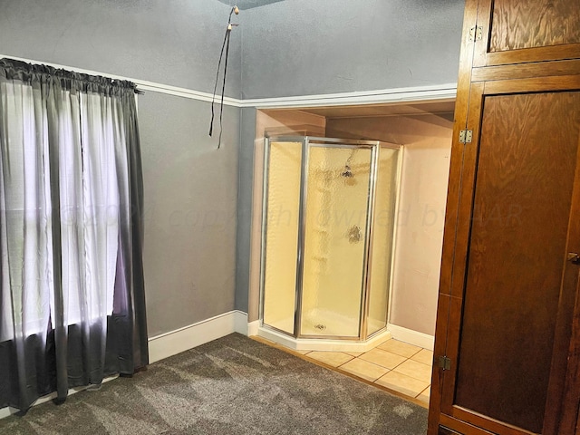 bathroom featuring an enclosed shower, a textured ceiling, and tile patterned floors