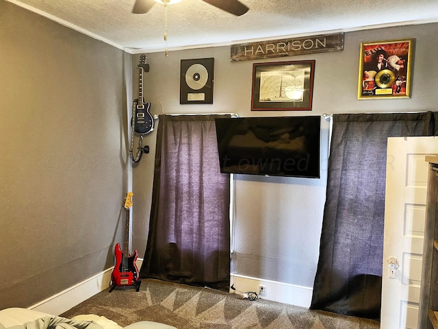 interior space with a textured ceiling and ceiling fan