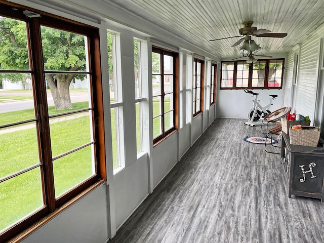 sunroom featuring wooden ceiling, a wealth of natural light, and ceiling fan