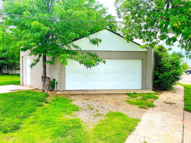 garage featuring a lawn