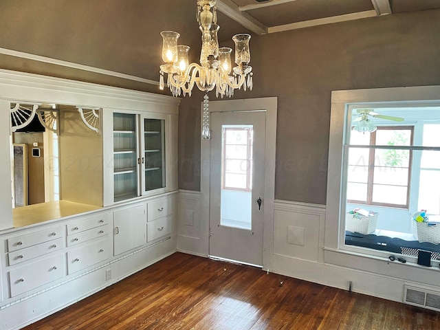 entryway with ceiling fan with notable chandelier and dark hardwood / wood-style flooring