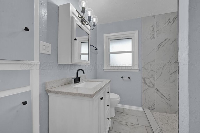 bathroom featuring a walk in shower, vanity, toilet, marble finish floor, and baseboards