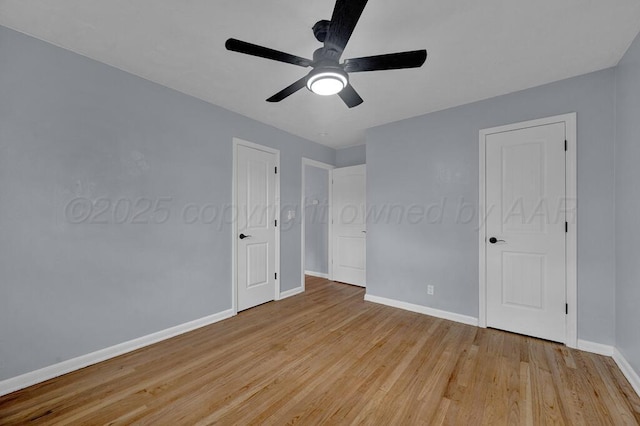 unfurnished bedroom with light wood-style flooring, baseboards, and ceiling fan