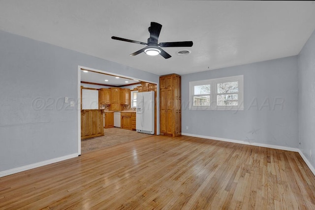 unfurnished living room featuring visible vents, ceiling fan, light wood finished floors, and baseboards