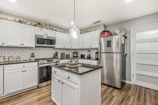 4639 S Hughes St, Amarillo, TX 79110 - kitchen with stainless steel appliances, light wood-style flooring, tasteful backsplash, white cabinets, and recessed lighting