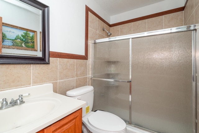 1608 Heather St, Amarillo, TX 79107 - bathroom with tile walls, vanity, toilet, and a tile shower