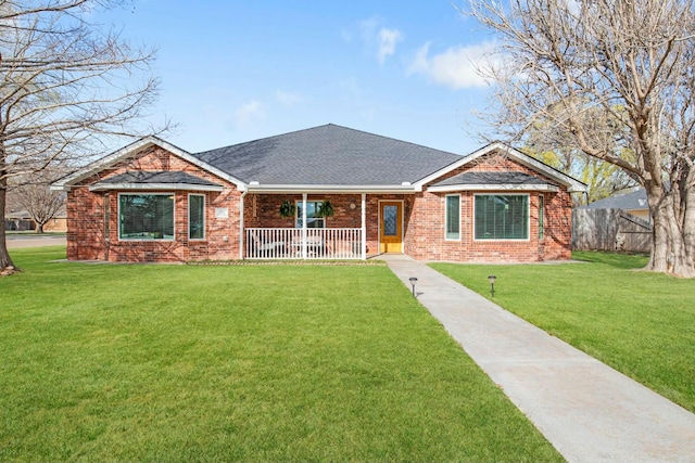 single story home featuring fence, a front yard, a porch, and brick siding