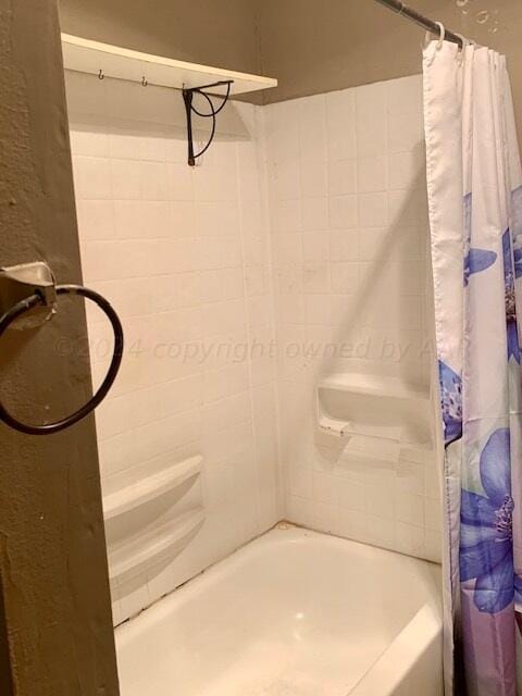 bathroom with shower / bathtub combination with curtain