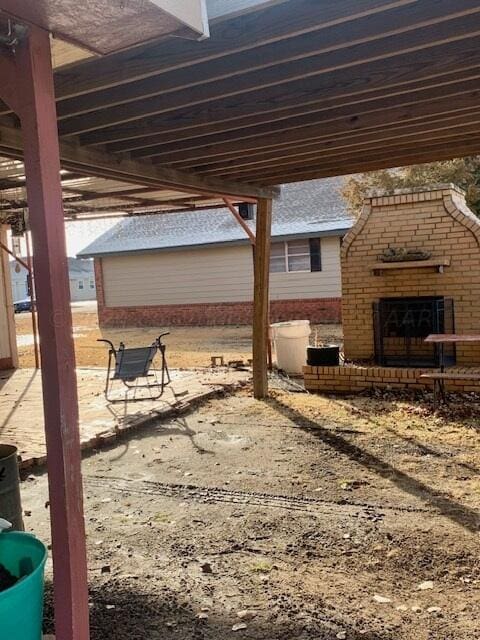 view of patio featuring an outdoor brick fireplace