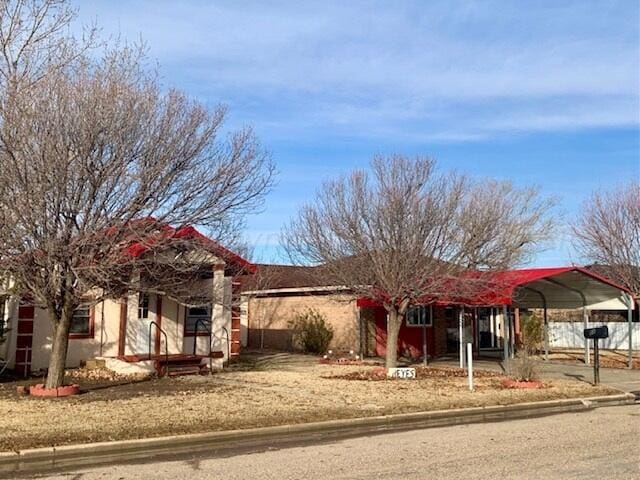 view of front of property featuring a carport