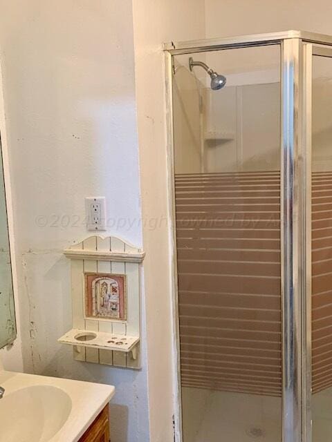 bathroom with an enclosed shower and vanity