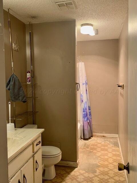 full bathroom with toilet, shower / bath combo, vanity, and a textured ceiling