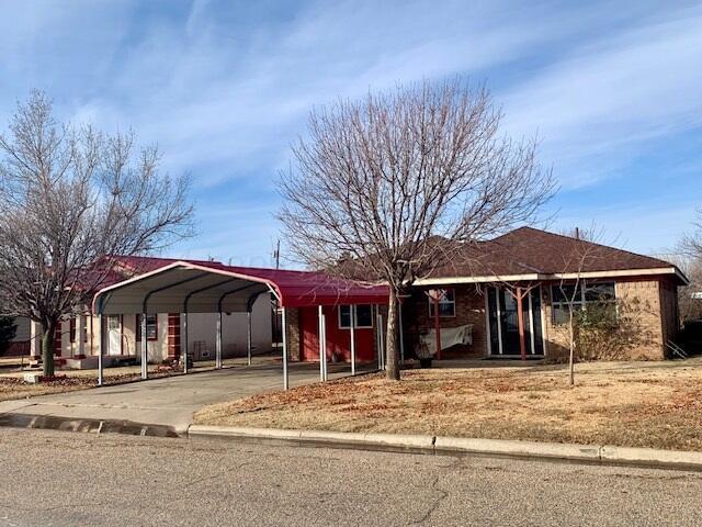 ranch-style home featuring a carport