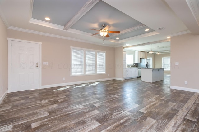 unfurnished living room with ceiling fan, a raised ceiling, dark hardwood / wood-style flooring, and ornamental molding