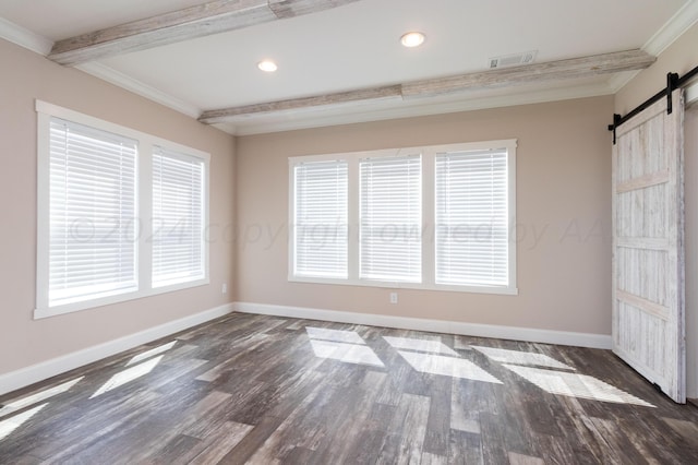 unfurnished room with beamed ceiling, a barn door, dark hardwood / wood-style floors, and plenty of natural light