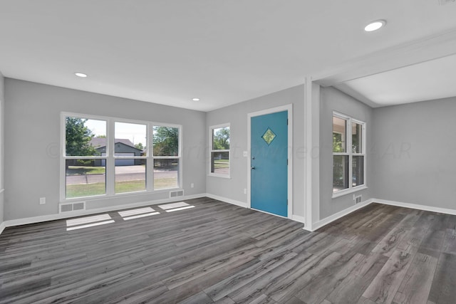 unfurnished living room with dark wood-style floors, recessed lighting, visible vents, and baseboards