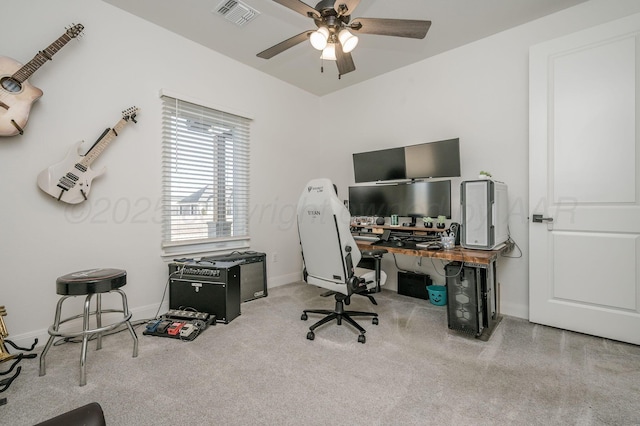 office space with baseboards, visible vents, and ceiling fan