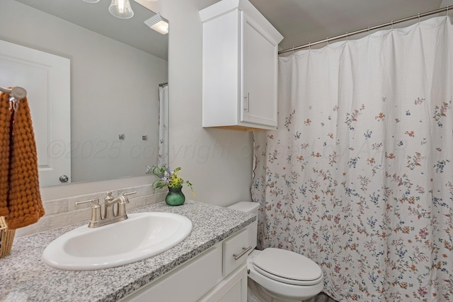 bathroom featuring toilet, a shower with curtain, and vanity