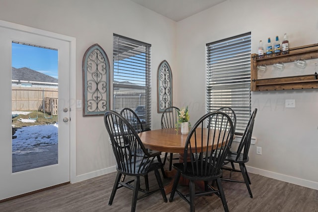 dining room with dark hardwood / wood-style flooring