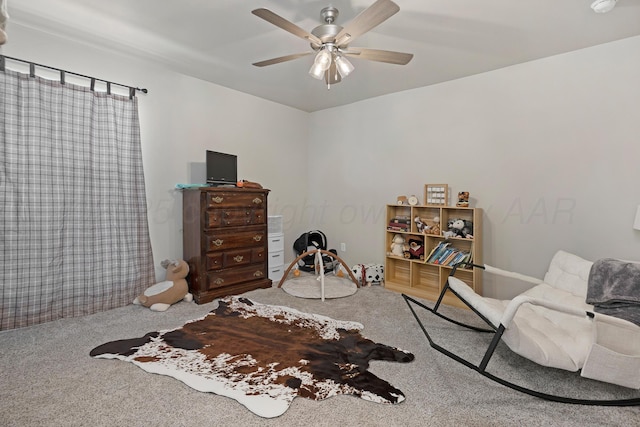 sitting room with ceiling fan and carpet