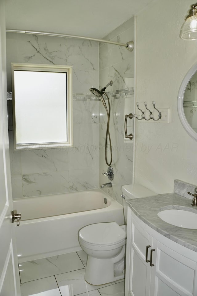 full bath with toilet, marble finish floors, vanity, and shower / bath combination