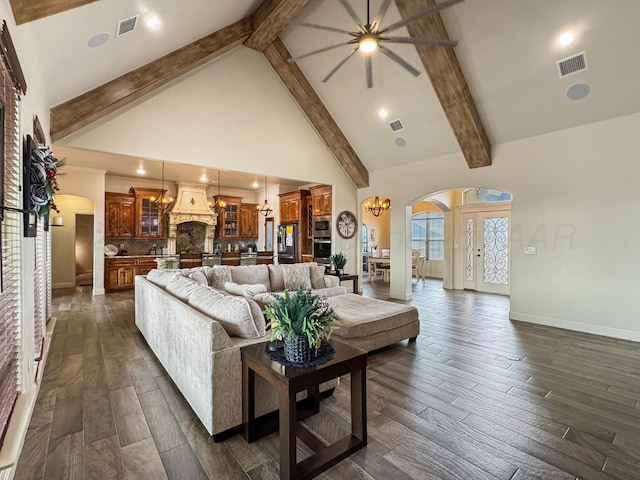 living room with beam ceiling, dark hardwood / wood-style floors, a notable chandelier, and high vaulted ceiling