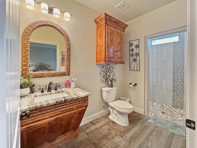 bathroom with vanity, toilet, and a shower