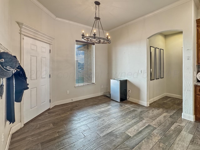 unfurnished dining area with a notable chandelier, crown molding, and dark hardwood / wood-style floors