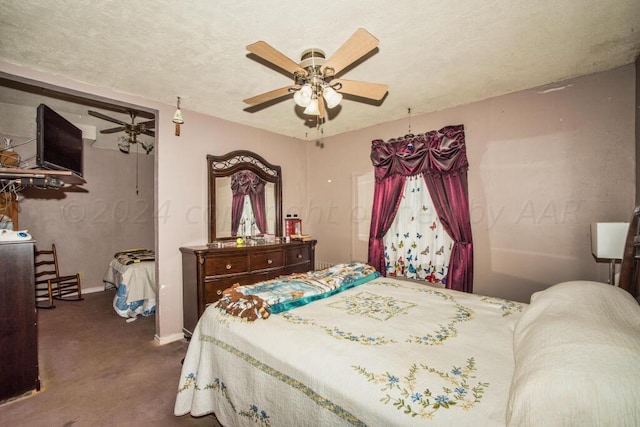 carpeted bedroom featuring ceiling fan and a textured ceiling