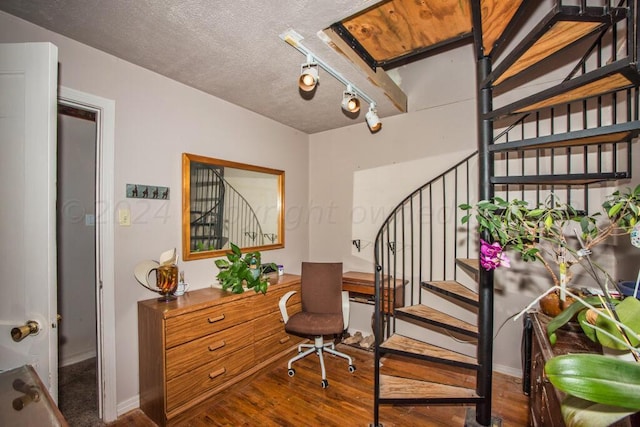 office with hardwood / wood-style floors and a textured ceiling