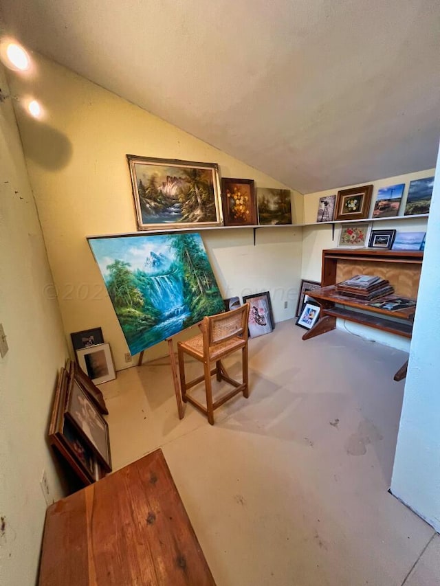 sitting room with lofted ceiling