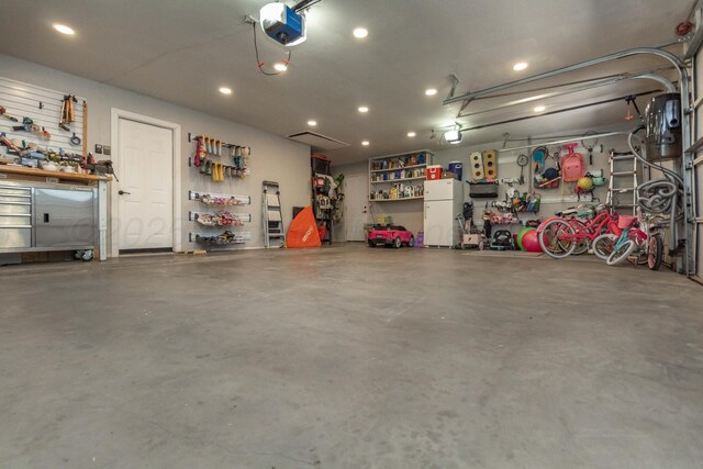 2112 Clubview, Amarillo, TX 79124 - garage featuring a workshop area, freestanding refrigerator, recessed lighting, and a garage door opener