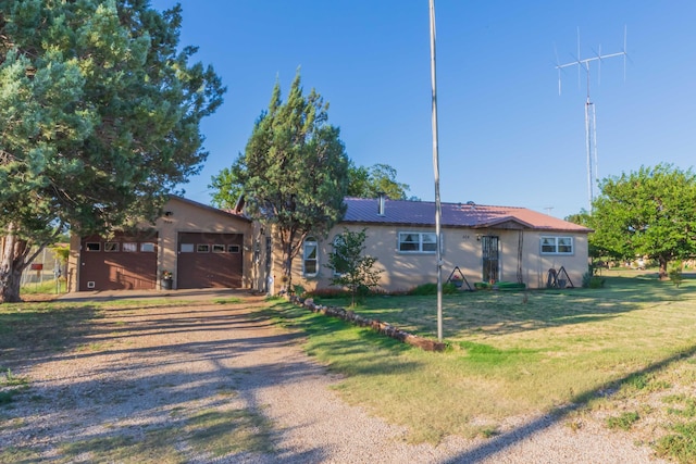 single story home with a garage and a front yard