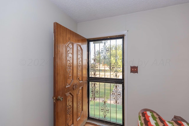 foyer entrance featuring a textured ceiling