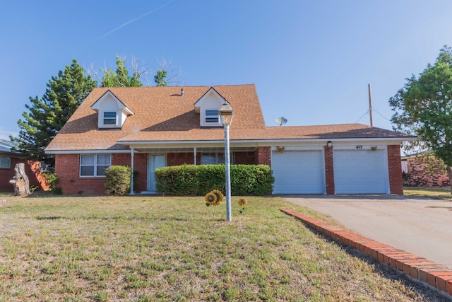 cape cod home with a garage and a front lawn