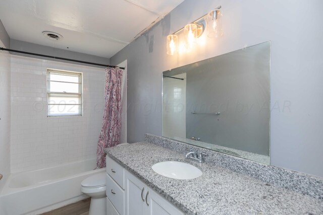 full bathroom featuring shower / bath combo with shower curtain, wood-type flooring, vanity, and toilet