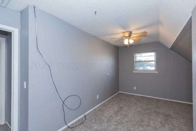 bonus room with ceiling fan, a textured ceiling, carpet flooring, and vaulted ceiling