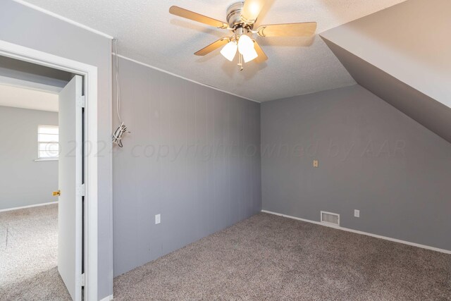 bonus room featuring ceiling fan, a textured ceiling, and carpet