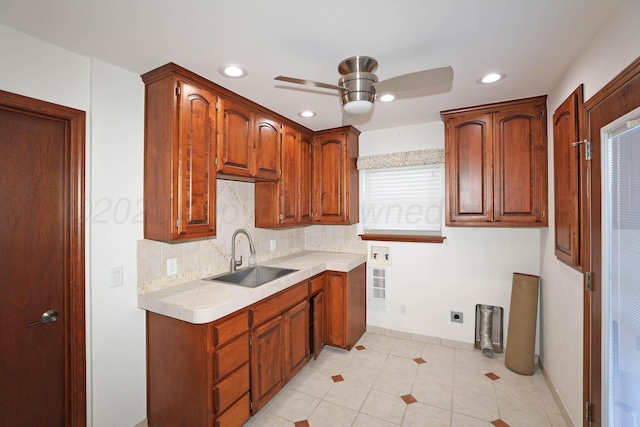 kitchen with ceiling fan, light tile patterned floors, sink, and backsplash