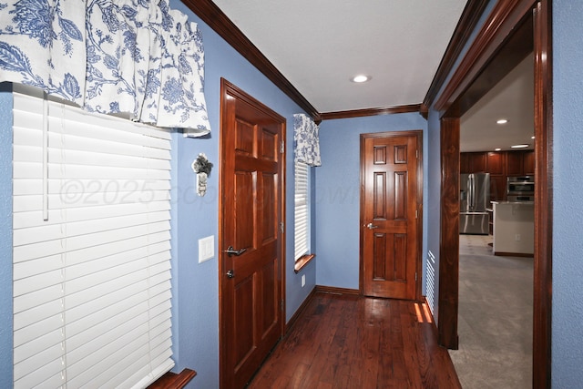 corridor with ornamental molding and dark hardwood / wood-style floors