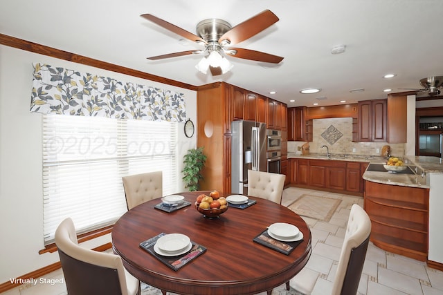 dining room with ceiling fan and sink