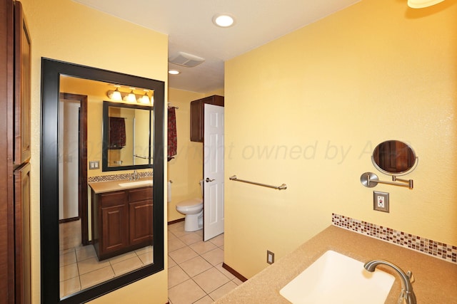 bathroom featuring tile patterned floors, vanity, and toilet