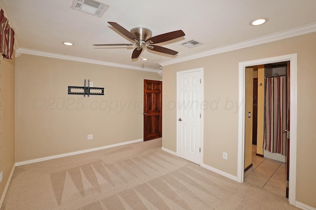 unfurnished bedroom featuring crown molding, light carpet, and ceiling fan