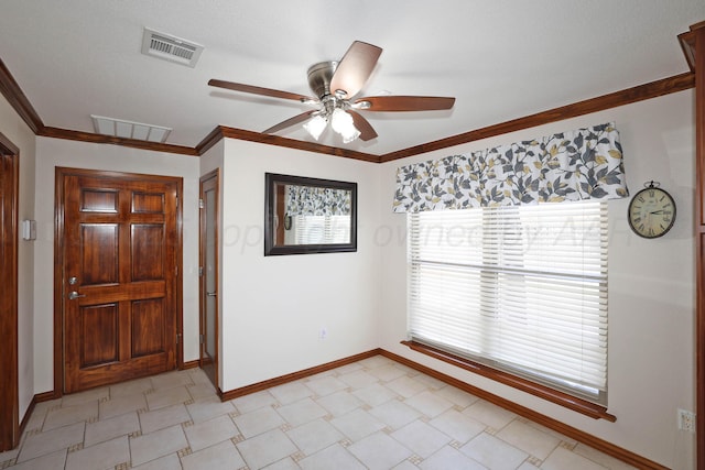 entrance foyer with crown molding and ceiling fan