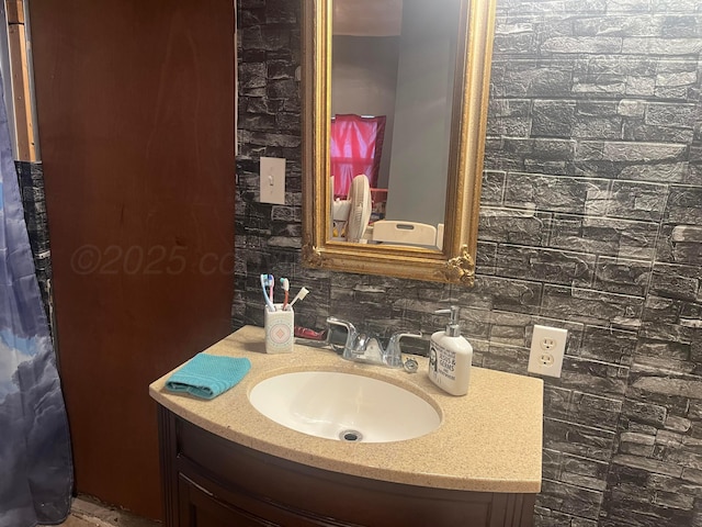 bathroom with vanity and tasteful backsplash