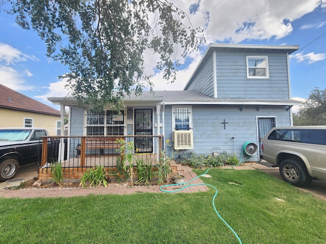 view of front of property with covered porch, cooling unit, and a front yard