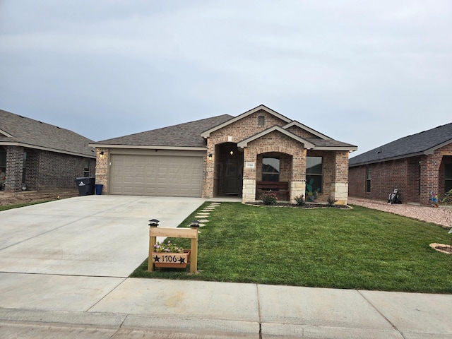 view of front of home featuring a garage and a front yard